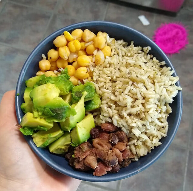 avocado, rice, chickpeas and beans in a blue bowl